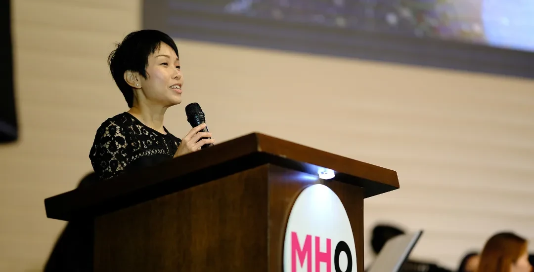 MHO founder speaking at podium